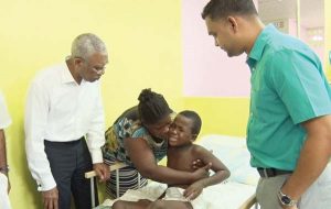  President Granger visits  recovering St Lucian Cub  Scout at GPHC.  Also present were his  mother Delia Finistere   and Dr. Amarnauth Dukhi
