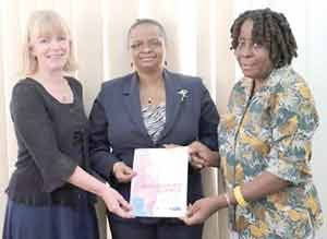 From left: Ms Marianne Flach, Minister Volda Lawrence and Ms. Karen Davis display a copy of the report