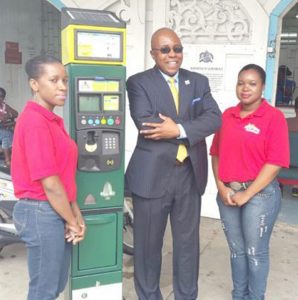 Ifa Kamau Kush, with two employees and the meter.