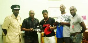 GBA president Steve Ninvalle hands over the equipment to Joshua Joseph in the presence of (from left) Prison Officer Adrian Thomas, GBA Technical Director Terrence ‘Cool’ Poole and Superintendent of Prisons Pilgrim.