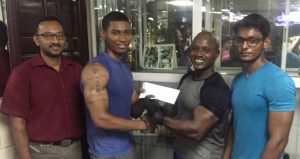Buddy’s Gym Supervisor Mervyn Moses (2nd right) hands over cheque to GAPF’s representative Demetri Chan in the presence of Nawaz Sheriffudeen (left) and Sohail Hussain. 