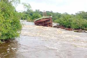 The sunken dredge as it sits in the river