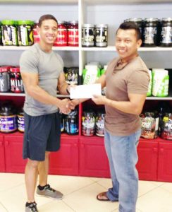 Owner/Manager of Fitness Express Jamie Mc Donald (left) hands over sponsorship cheque to GAPF’s Tai Eusebio.  