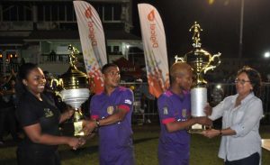 Minister of Indigenous People’s Affairs Valarie Garrido-Lowe (right) presents the winning trophy to Mabaruma captain Albert Smith, while Leuanna Abrams (left) of Digicel hands over the MVP prize to Kareem Knights.