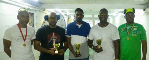 Gordon Richards (2nd right) along with the four other top shooters displaying their trophies and medals.