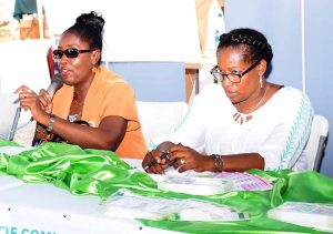 Minister within the Ministry of Communities, with responsibility for Housing, Valerie Patterson, at the head table with Director of Operation Ms. Denise King-Tudor during their engagement with the gathering.