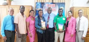 Finance Controller of NAMILCO Mr. Fitzroy McLeod (center of athletes, Alita Moore to his right and Winston George) along with other top brass of NAMILCO and Mr. Boyce of the Boyce /Jefford Track and Field Classic with the athletes following the presentation. 