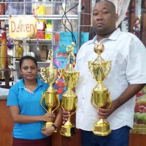 RHTY&SC Secretary/CEO Hilbert Foster receives trophies from a representative of Factory Price Store.