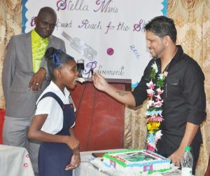 Sarwan cuts his retirement cake with his image on it with Crystal Spencer at Stella Maris on Thursday.