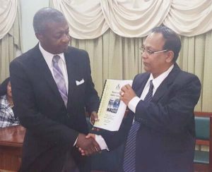 Auditor General, Deodat Sharma hands over his 2015 Report to House Speaker, Dr. Barton Scotland (left).