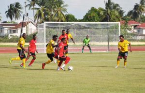 T&T’s National Under-20s on the offensive against Alpha United yesterday. (Franklin Wilson photo)