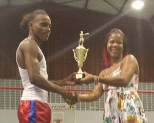 WIBA champion, Shondell Alfred, is all smiles as she presents Keevin Allicock with his championship trophy. 