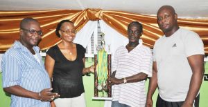  Senior organising secretary of the Georgetown Dominoes Association (GDA) Mark Wiltshire (2nd from right) with Lindon Boston (right), Faye Hunte (2nd from left) and Neville Cadogan display some of the prizes.