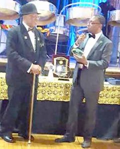 Founder Rudy Bishop (left) is presented with a Lifetime Achievement award