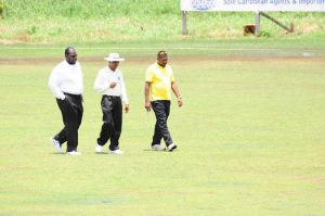 The umpires during an inspection of the field yesterday.