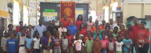 Rotaract officials gathered with students of the literacy program.