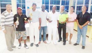 Mr. Vibert Austin and Mr. Oncar Ramroop pose with the day’s winners. From Left; J. Medina, I. Khan, F. Haniff, Mr V. Austin, C. Adams, P. Persaud, I. Gouveia, and President O. Ramroop.