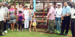 Members of the Zorg SC with Dereck Gobin (4th from right), Region two chairman Devanand Ramdatt (2nd from right) and little Xia Sankar (center) with her mom Shevon Simon just after the cutting of the ribbon to mark the opening of the pavilion.