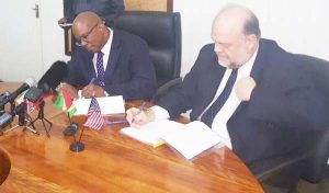 Finance Minister, Winston Jordan and USA Ambassador to Guyana, Perry Holloway during the signing of the FATCA Agreement.
