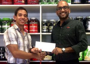 Managing of Fitness express Jamie McDonald (left) hands over contribution to Navin Singh.