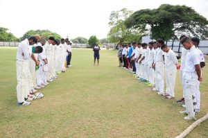 Players and officials observing a minute silence for the late  Pritipaul George prior to the start of the second day’s play  between West Demerara and lower Corentyne. 
