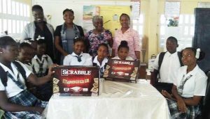 The children show off the scrabble sets along with Headmistress, Yvonne Adams (2nd left) and other teachers, Donette Butters (extreme left) and Odessa Smith Barker (extreme right). Yvonne Murray is 3rd left.