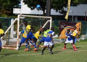 Part of the action between St. Pius and Winfer Gardens yesterday at Thirst Park.