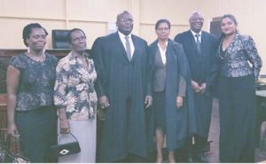  Attorney-at-law Jason Moore with Justice Sandra Kurtzious, Attorney-at-law Gordon Gilhuys, family and friends after being admitted to the Bar.