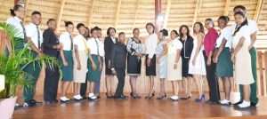 Minister Nicolette Henry (centre) with Latoya Roberts (left of her) flanked on both sides by other law graduates and students from The Bishops’ High School and Queen’s College.