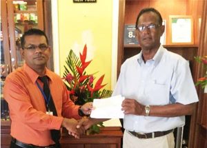 In picture, Manager, Mr Ramesh Taykoo (left), hands over the sponsorship cheque to Mr Patricik Prashad, Vice President of the Lusignan Golf Club.