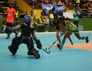 Trinidad and Tobago national Captain Allana Lewis (green uniform), who is a guest player for Woodpecker Hikers about to attempt a flick past the advancing Old Fort goalkeeper on Wednesday evening.