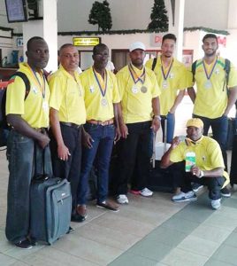 Deion Nurse (left) and Sean Erskine (2nd left) join other members of the triumphant team shortly after returning to Guyana.