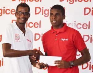 Head of Customer Care Sherwin Osbourne (left) hands over the ticket to Sporting Lisbon bound Jeremy Garrett at the Digicel Head Office yesterday.