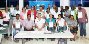 Mr. Jose De Jesus of FINA (Centre), GASA head Ivan Persaud (sitting 2nd from left,)Vice President Ms Elke Rodrigues (sitting 3rd from right) and participants display their certificates. 