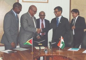 Minister of Finance Winston Jordan (second from left) exchanging the signed LOC agreement with Exim Bank representative Sailesh Prasad (second from right) in the company of Minister of Public Infrastructure David Patterson (right) and Indian High Commissioner Mr. V. Mahalingam (third from right) 