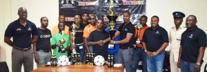  Banks DIH Representative Ian Charles (5th right) hands over the winning trophy to a team rep Mark Carrega in the presence of Guinness Brand Executive Lee Baptiste (left), Petra Organisation Troy Mendonca (2nd right), Troy Peters (right) and teams officials yesterday.