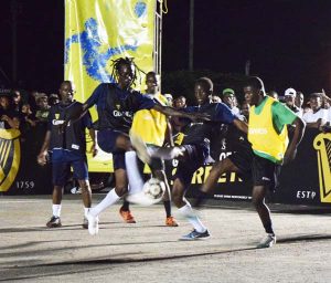 National striker Dwight Peters (yellow bib) appearing for Bent Street fights for possession of the ball during their clash with Holmes Street of Tiger bay.