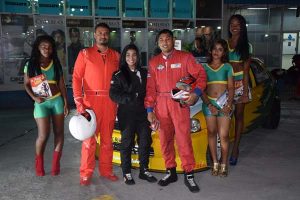 Racing drivers (from left) Shairaz Roshandin, Sharima Khan and Paul Jewanram pose with Rent-a-Tent models on Saturday evening at the Giftland Mall.  