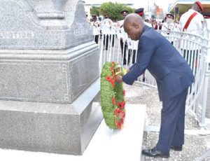 Minister of Foreign Affairs, Carl Greenidge lays his wreath