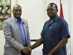 Minister of State, Joseph Harmon, last evening, shaking hands with the Commissioner of the newly established Board of Inquiry, Winston Cosbert.