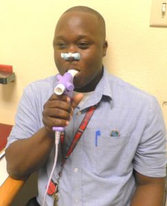 Demonstrating the use of a spirometer