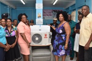President of the Organisation for Social and Health Advancement in Guyana (OSHAG), Carol Bagot hands over the Air Condition unit to Acting Assistant Director of Nursing, Celeste Gordon