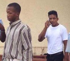 Wilton Leps, (in white shirt) and Rayon Scott (in checkered shirt) in court yesterday.