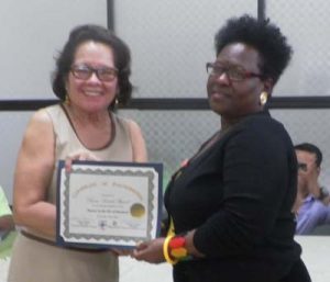 First Lady Sandra Granger presenting a participant with her certificate.