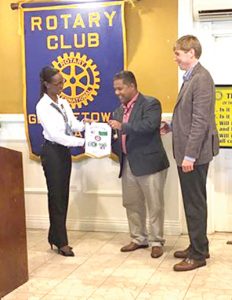 President Lisa Foster, Rotary Club Georgetown receiving the Wake Forest Rotary Club flag presented by Rotarians Mark S Vasconcellos and Joel Beckham  