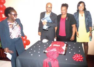 Caricom officials admire a World AIDS Day cake 