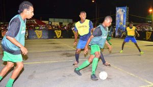 Players battle for possession of the ball during one of the encounters on Thursday, at Demerara Park. 