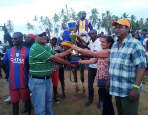 Mr and Mrs Persaud receives the Republic Bank trophy from Gobin Harbajan.