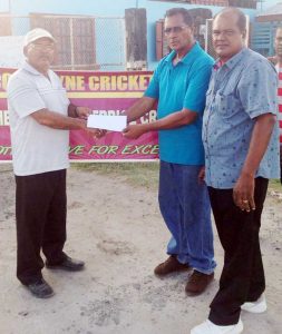 Mr. Thakurdial Tulshi (2nd right) hands over the cheque to UCCA President Mr. Dennis De Andrade. Also in photo is UCCA Secretary Mr. Winston Roberts. 