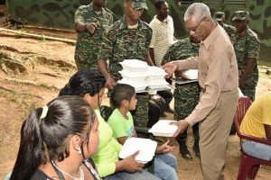 President Granger serving lunch to some of the villagers who were present at the event today.